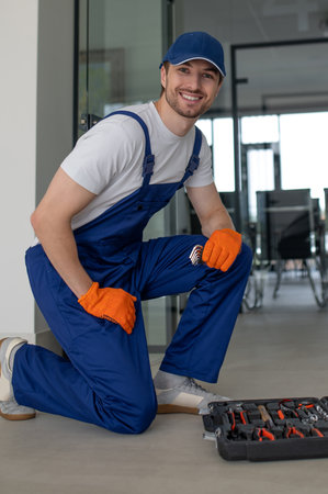 Technician installing handles and locks on glass doorsの写真素材