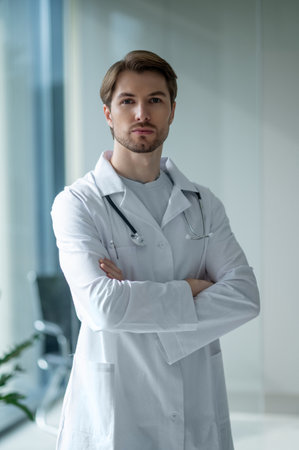 Medical professional with stethoscope posing in modern clinicの写真素材