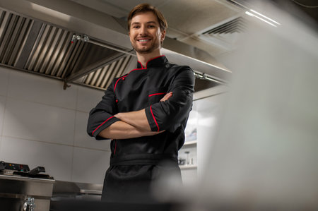 Professional chef standing in modern kitchen