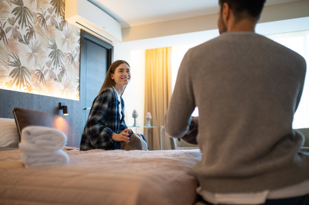 Young couple unpacking after arrival to the hotel for vacationの写真素材