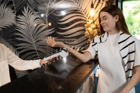 Customer paying for hotel accommodation on reception deskの写真素材