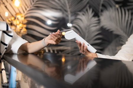 Customer paying for hotel accommodation on reception deskの写真素材