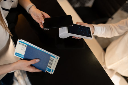 Customer paying for hotel accommodation on reception deskの写真素材