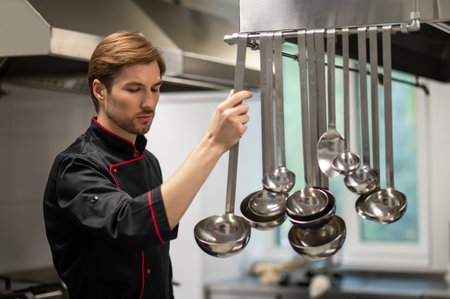Male cook working in professional kitchenの写真素材