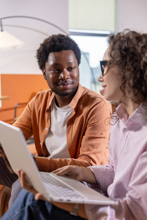 Woman wearing glasses explaining something during discussion with colleagueの写真素材