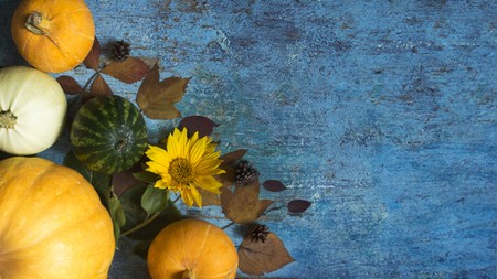 Pumpkin, watermelon and autumn leaves on a wooden background.の写真素材