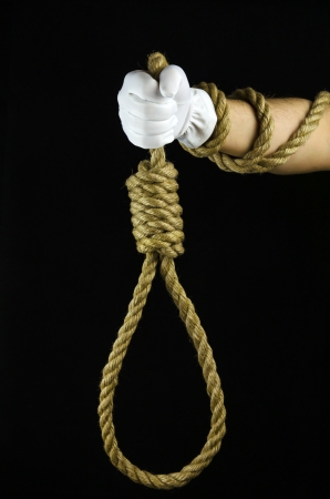 Hand in a white glove holding a noose to the gallowsの写真素材