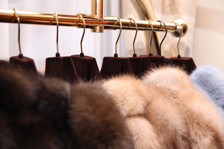Chic expensive fur coats with natural fur on the hangerの写真素材