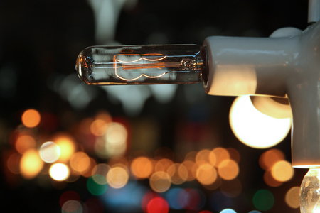 Included light bulb on the background of colorful lightsの写真素材