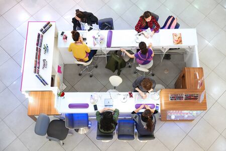 Girls use the service of Express manicure in the shopping center "Good". Moscow. 12.10.2018のeditorial素材