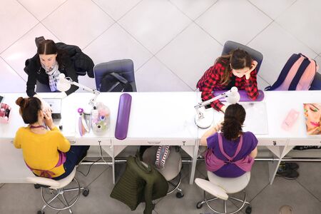 Two girls do Express manicure in the shopping center "Good". Moscow. 12.10.2018のeditorial素材