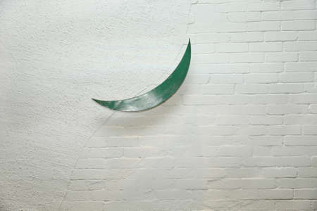 White wall painted with paint with green moon decoration attachedの写真素材