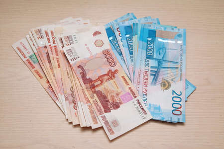 Banknotes of the Bank of Russia on the table, in denominations of 1000, 2000 and 5000 rubles....