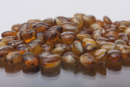 amber heart shape surrounded by ornamental stonesの写真素材