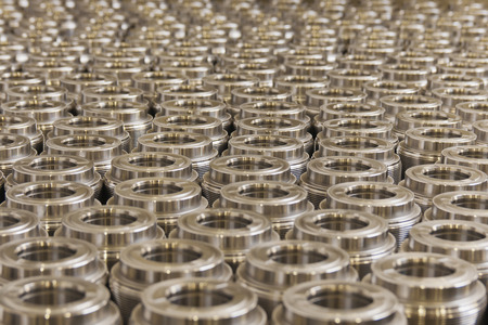 photograph shows a threaded metal bushings on the surface, ready for processing heat 