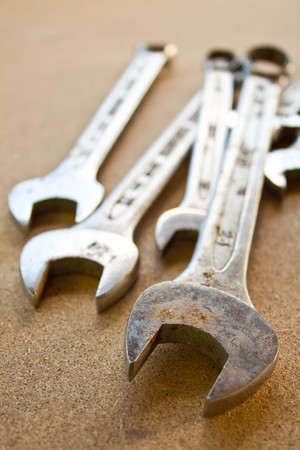 Close up view of spanner on wood boardの写真素材