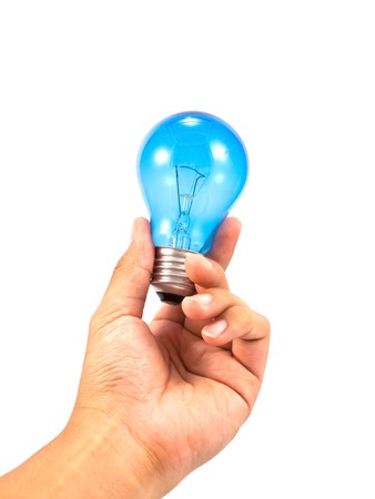 Lightbulb in a hand isolated on white background.の写真素材