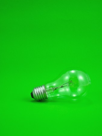 Compact light bulb isolated on green backgroundの写真素材