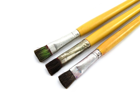 close up of paint brushes on white background