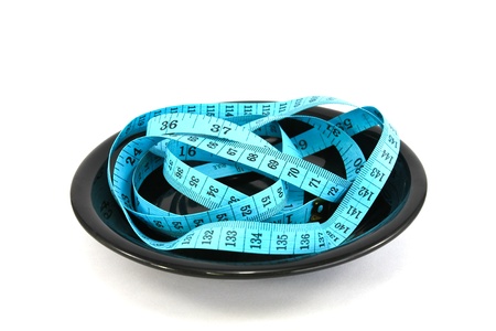 plate with tape measure isolated on white