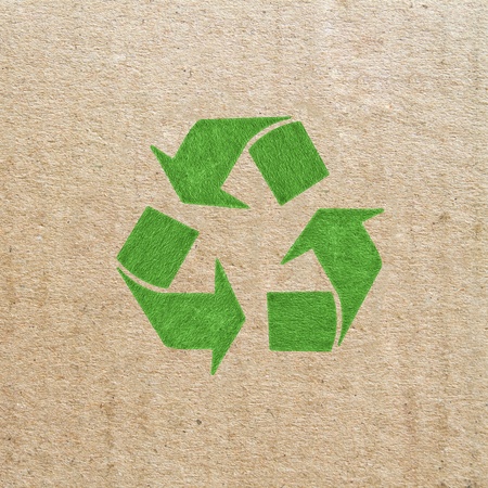 Brown corrugated cardboard sheet background with recycled signの写真素材
