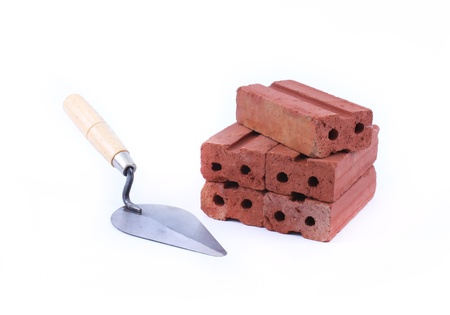 Trowel and red brick isolated on white backgroundの写真素材