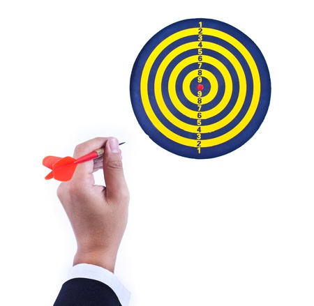 dart in hand and dartboard isolated on white backgroundの写真素材