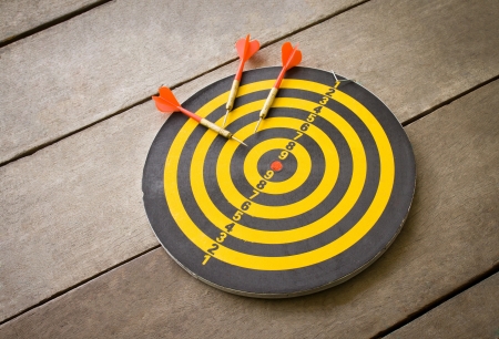 dartboard and dart on wood floorの写真素材