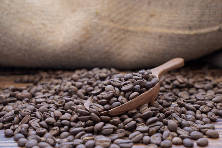 coffee beans in wooden spoonの写真素材