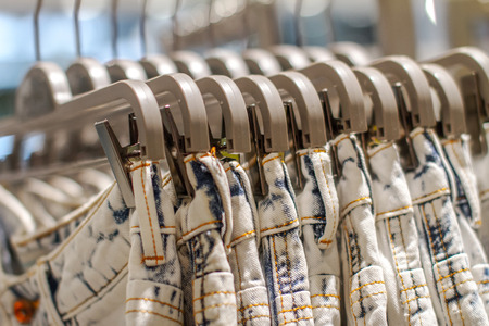 a Preview jeans hanging on a hanger in the store の写真素材