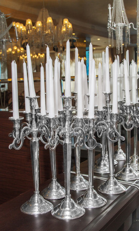 a Image of white candles in silver candlesticksの写真素材