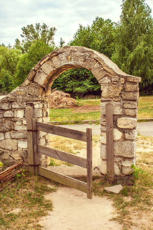 Image wooden gate in the stone fenceの写真素材