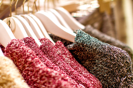 image red yellow knitted sweater hanging on the hangerの写真素材