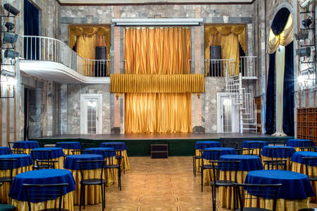 Image of a theater stage in front of tables in an empty cafÃ©の写真素材