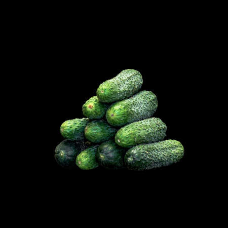 Image of a pyramid of cucumbers on a black backgroundの写真素材