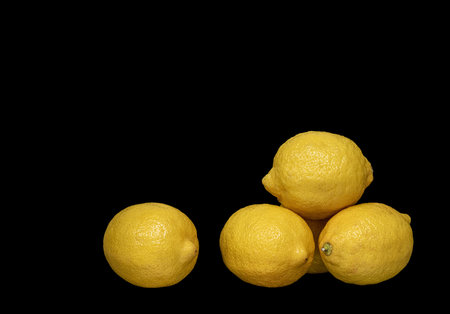 Image of ripe lemons on black backgroundの写真素材