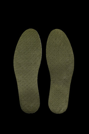 Image of green shoe insoles on black backgroundの写真素材