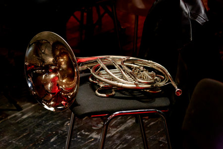 Image of a musical wind instrument horn lies on a chair