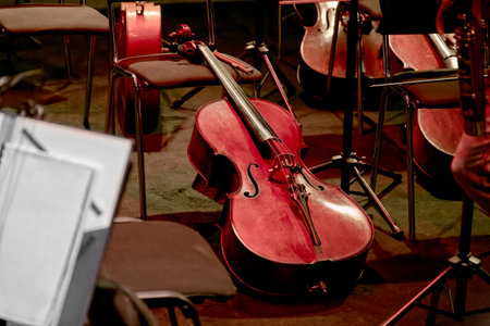 Image of a stringed musical instrument cello lies in the orchestra pitの写真素材