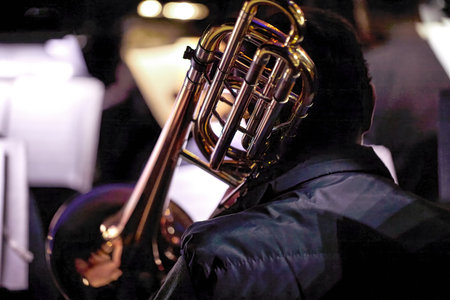 Image of a symphony orchestra musician playing the trombone