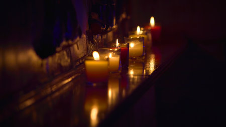 Image of red and yellow decorative candles in glasses on a shelf