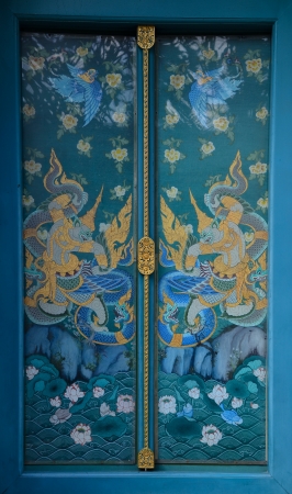 Thai temple door with ramayana paintingの写真素材