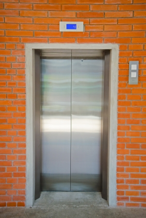 modern elevator with brick wallの写真素材