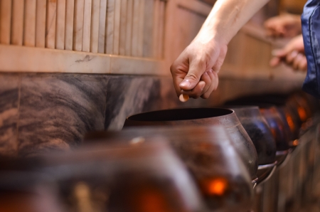 tradition thai donation, throwing coin into monk alms bowlの写真素材