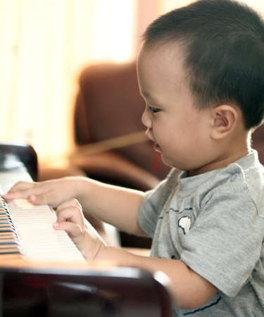 The baby hands play the piano.の写真素材
