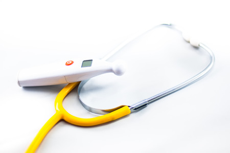 Yellow Stethoscope with thermometer isolated white