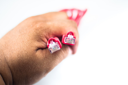 Hand hold the Red Network Cableの写真素材