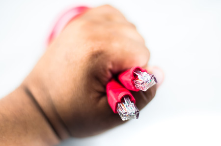 Hand hold the Red Network Cableの写真素材