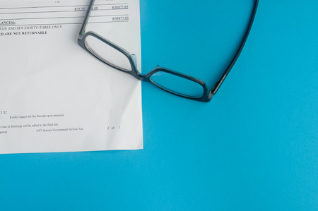 Hospital bills and glassesの写真素材