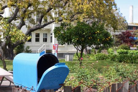 Blue mailbox in quiet neighborhoodの写真素材